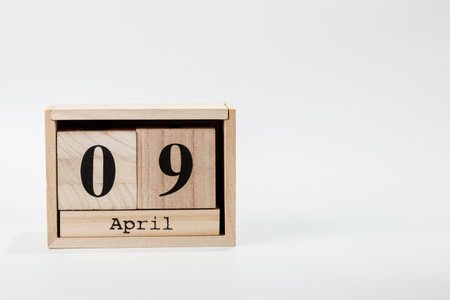 Wooden calendar April 09 on a white background close upの写真素材