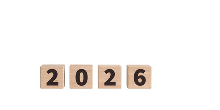Wooden blocks with "2026" text on a white background are ideal for New Year decor. Their rustic charm adds a warm touch to festive or planning designs.の写真素材