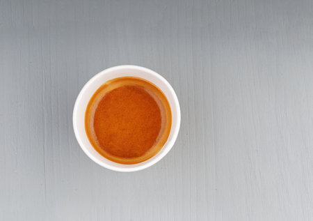 top view cardboard cup with coffee, espresso, americano on gray wooden background close-upの写真素材