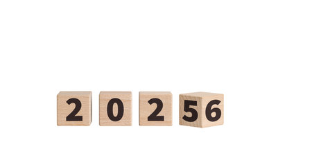 Wooden blocks with "2025" text on a white background enhance New Year celebrations. Their wooden texture brings a cozy feel to holiday decorations.の写真素材