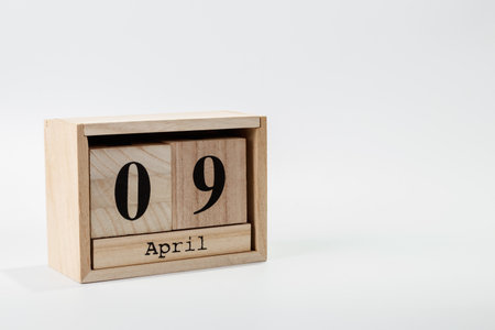 Wooden calendar April 09 on a white background close upの写真素材