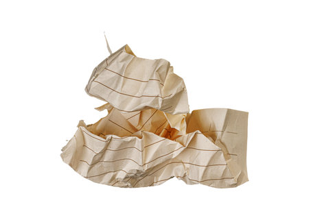 A crumpled checkered paper sheet on a white background suits artistic projects. Its wrinkled grid inspires sketches for artists seeking unique textures.の写真素材