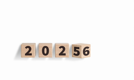 Wooden blocks with "2025-2026" text on a white background enhance New Year celebrations. Their wooden texture brings a cozy feel to holiday decorations.の写真素材