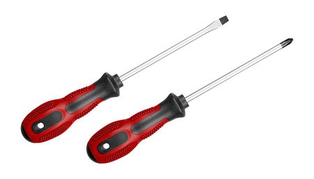 Two screwdrivers, flat and Phillips, are perfect for repair and maintenance tasks. Their ergonomic Red handles provide comfort during long use on isolated white background close-upの写真素材