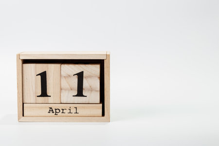 Wooden calendar April 11 on a white background close upの写真素材