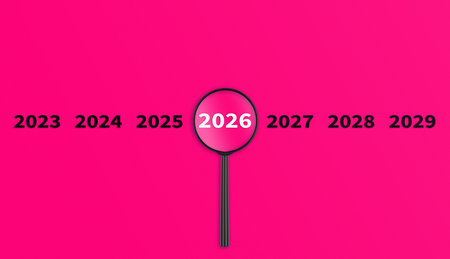 Lens, magnifying glass focusing on the year 2026 on a Pink background. Financial or stock market strategies and past and future events. Close-upの写真素材