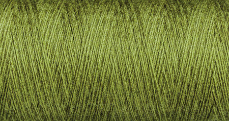 A green thread texture with weave suits various design projects. Its intricate pattern adds a vibrant depth to creative works.の写真素材