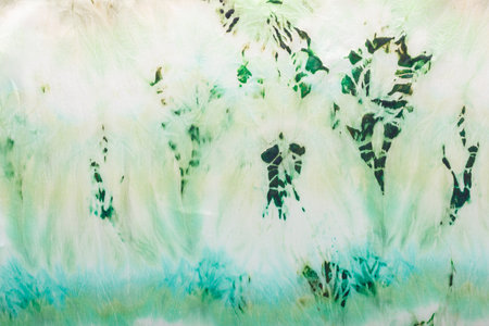abstract pattern on silk fabric texture in green tones close upの写真素材
