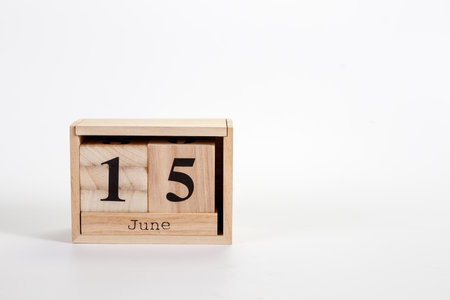 Wooden calendar June 15 on a white background close upの写真素材