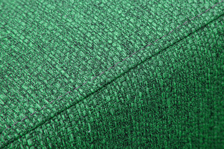 Textured green furniture fabric with stitching close-upの写真素材