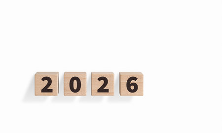 Wooden blocks with "2026" text on a white background are ideal for New Year decor. Their rustic charm adds a warm touch to festive or planning designs.の写真素材