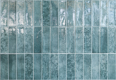 A glossy green tile texture on a white background suits interior design projects. Its shiny finish adds a modern elegance to decor visuals.の写真素材