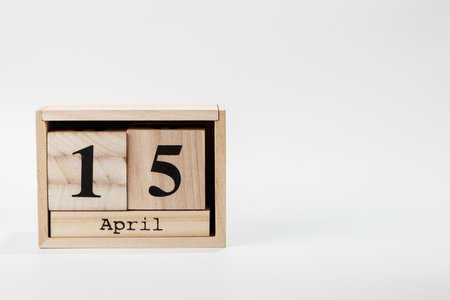 Wooden calendar April 15 on a white background close upの写真素材
