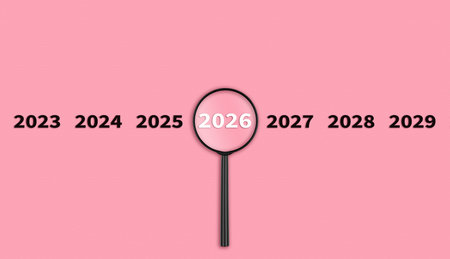 Lens, magnifying glass focusing on the year 2026 on a red background. Financial or stock market...