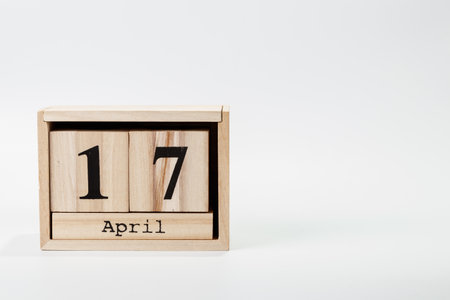 Wooden calendar April 17 on a white background close upの写真素材