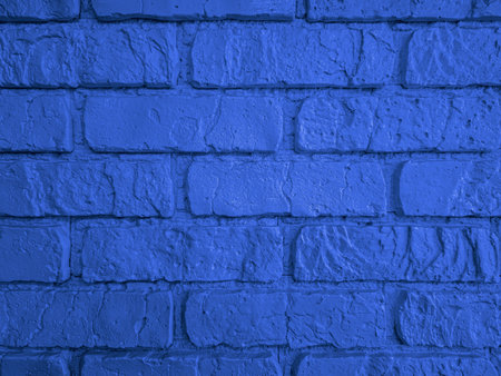 A blue brick wall texture with a rugged surface enhances interior decor. Its bold color creates a...