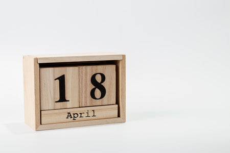 Wooden calendar April 18 on a white background close upの写真素材