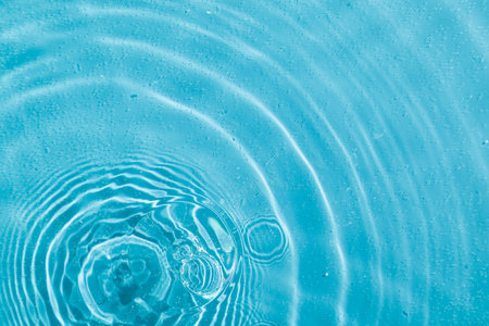 drops on water with circles on a blue background close up