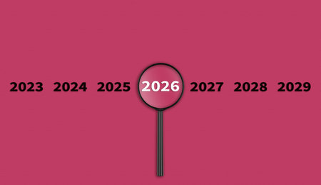 Lens, magnifying glass focusing on the year 2026 on a red background. Financial or stock market strategies and past and future events. Close-upの写真素材