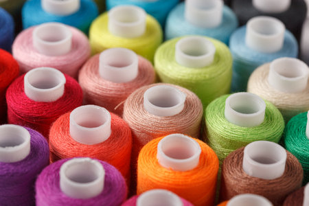Set of colorful spools of thread close up