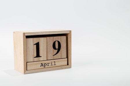 Wooden calendar April 19 on a white background close upの写真素材