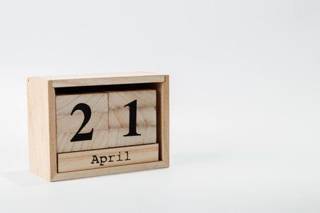 Wooden calendar April 21 on a white background close up