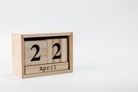 Wooden calendar April 22 on a white background close upの写真素材