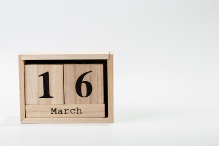 Wooden calendar March16 on a white background close upの写真素材