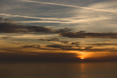 beautiful view of the sea in the evening with clouds and sunsetの写真素材