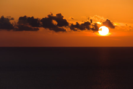 beautiful view of the sea in the evening with clouds and sunsetの写真素材