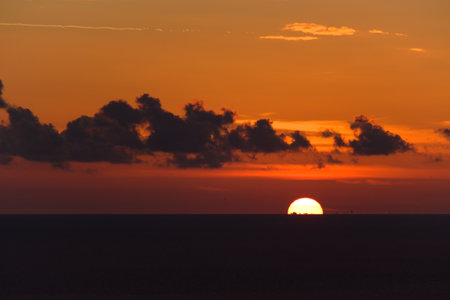 beautiful view of the sea in the evening with clouds and sunsetの写真素材