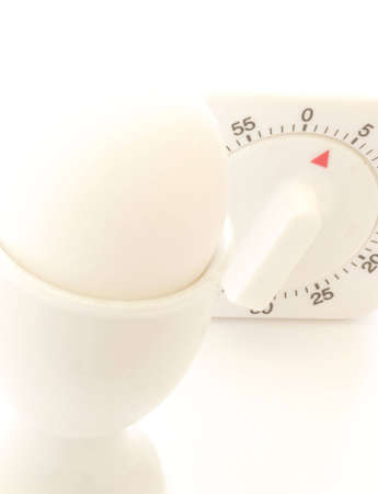 soft boiled egg with timer in background indicating three minutesの写真素材
