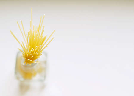 spaghetti noodle details in glass jar with room for copyspaceの写真素材