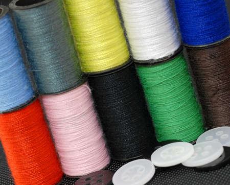 several colors of sewing thread and buttons