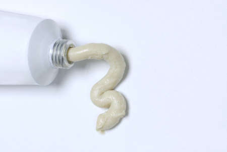 white tube with ointment or cream coming out (room for copyspace)