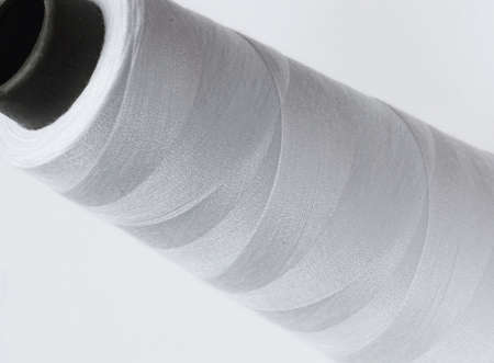 large size spool of white thread on white background