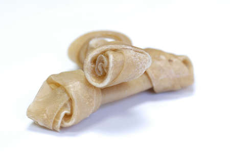 two knotted rawhide bones on white background