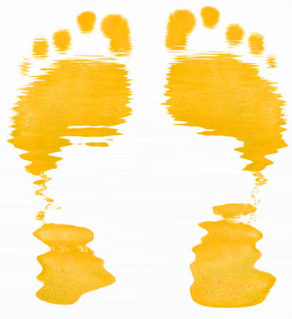 yellow abstract of two foot prints on white backgroundの写真素材
