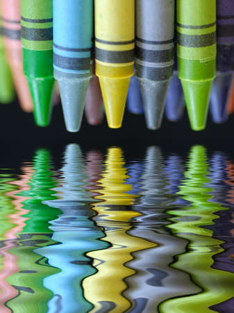 colorful crayons with beautiful reflection on black backgroundの写真素材