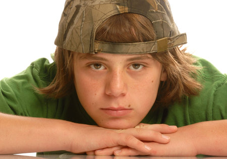 attractive young teen boy with ball cap on backwardsの写真素材