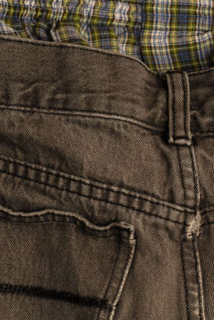 black denim jeans with plaid boxers showing at the top