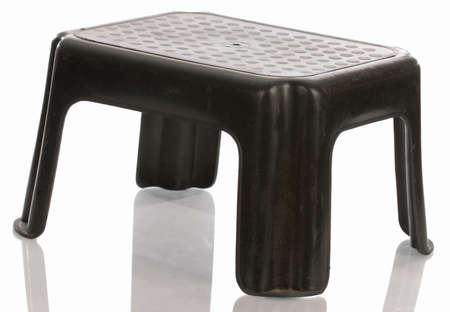 black step stool with reflection on white background