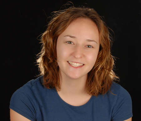 attractive happy young woman on black backgroundの写真素材