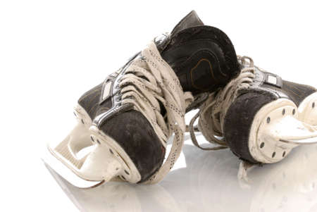 ice hockey skates with reflection on white backgroundの写真素材