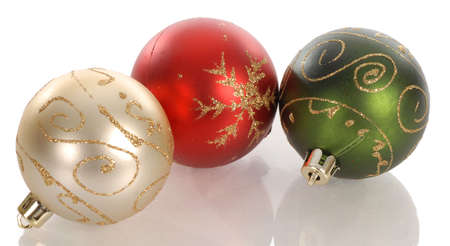 three colorful christmas balls with reflection on white backgroundの写真素材