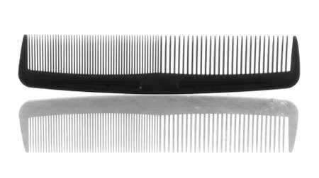 black plastic hair comb with reflection on white backgroundの写真素材