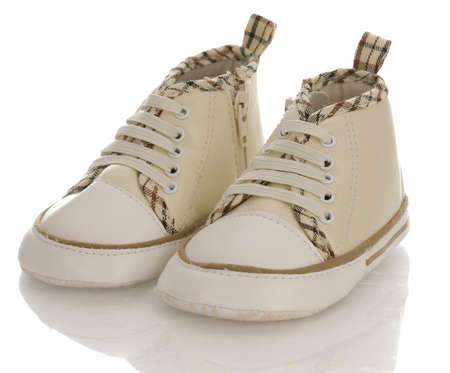 baby or infant running shoes with reflection on white backgroundの写真素材