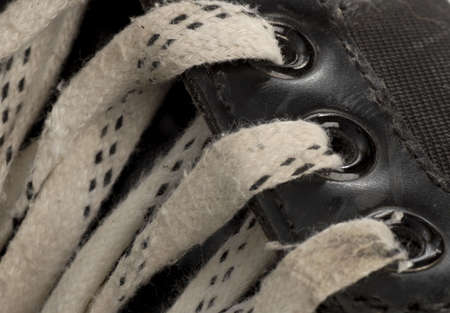 laces details on pair of worn hockey skateの写真素材