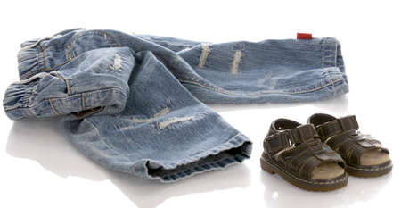 infant or baby jeans and sandals with reflection on white backgroundの写真素材