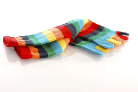 pair of colorful toe socks with reflection on white backgroundの写真素材